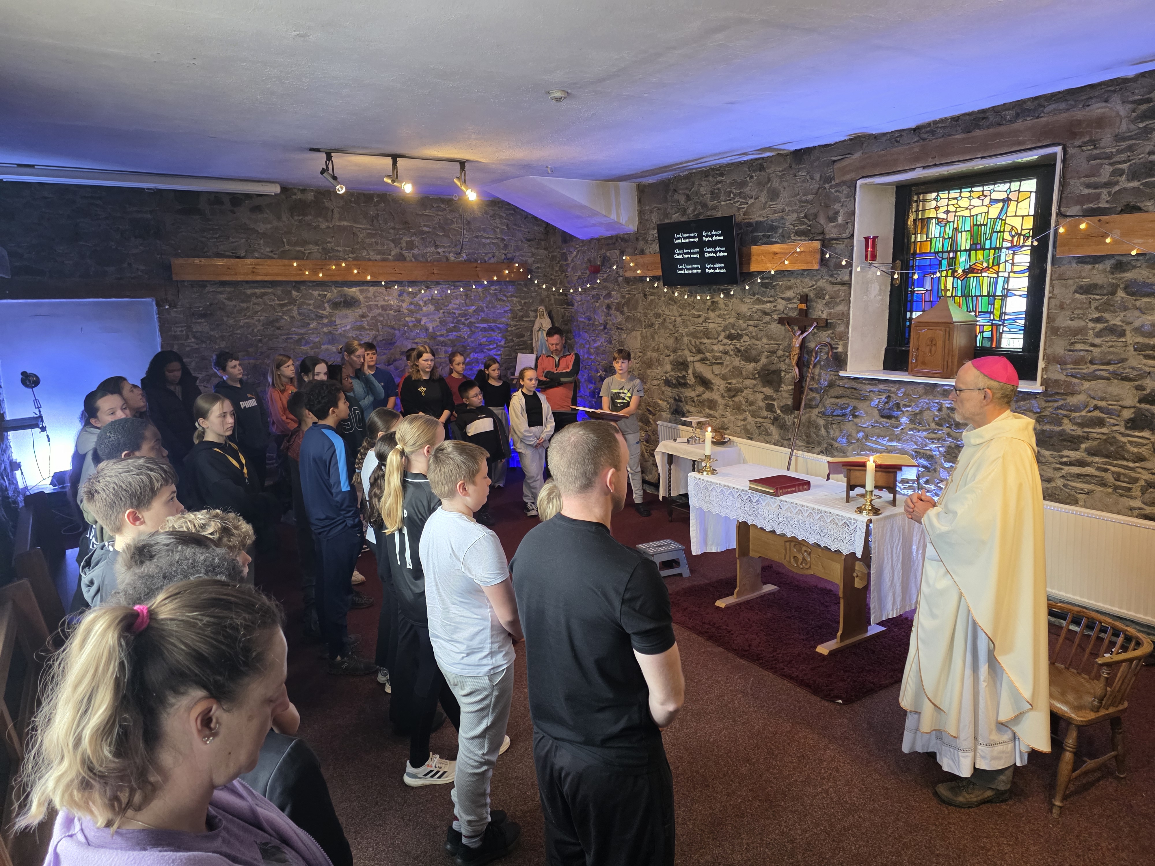 Young people gathered with their leaders and the bishop in the chapel at Castlerigg