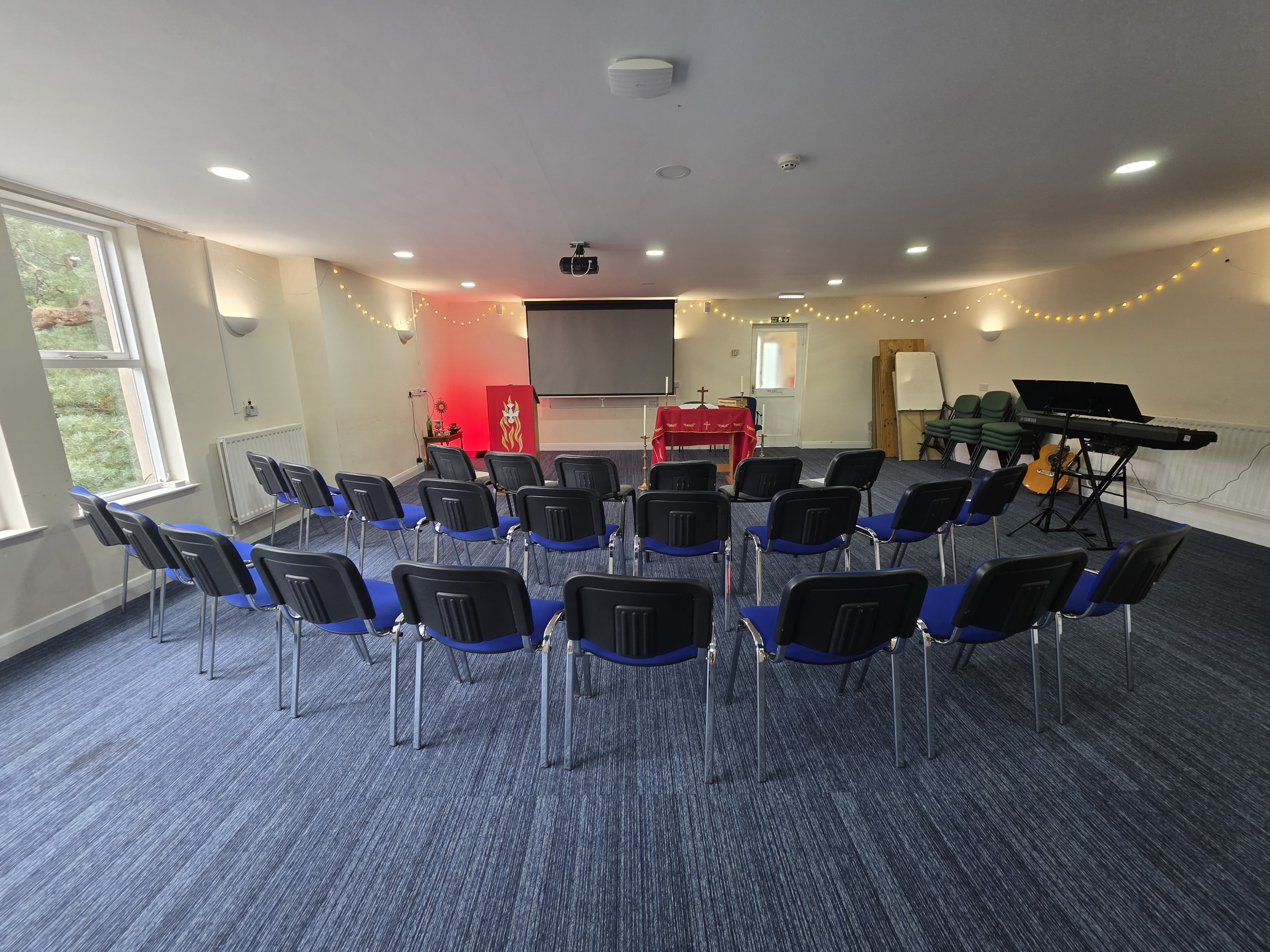 The conference room set out in rows facing the screen