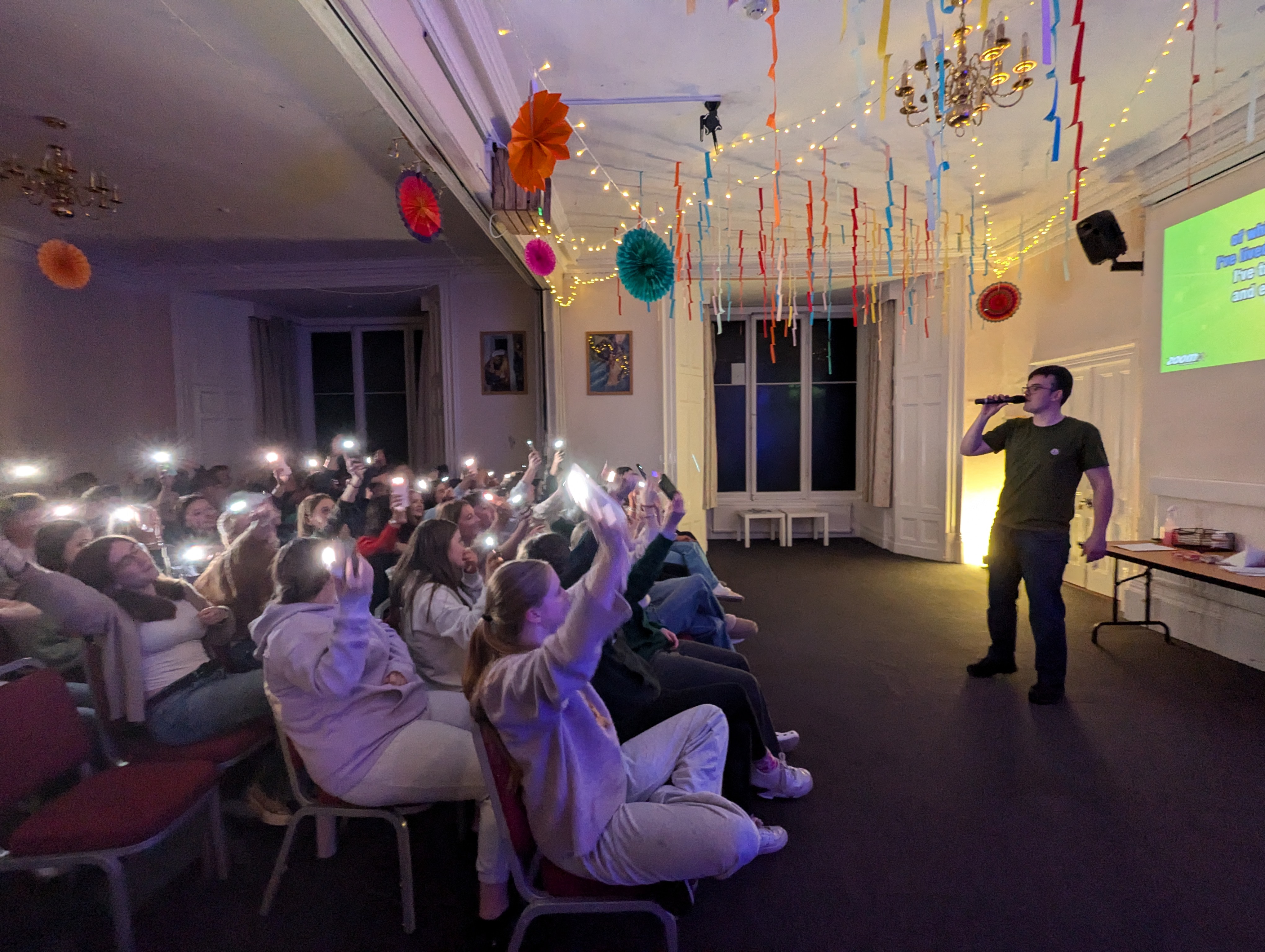 Young people worshipping with lights raised